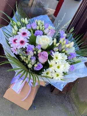 Lilac and cream dream bouquet. Lilac lisianthus, cream roses and chrysanthemums. Boxed bouquet in water