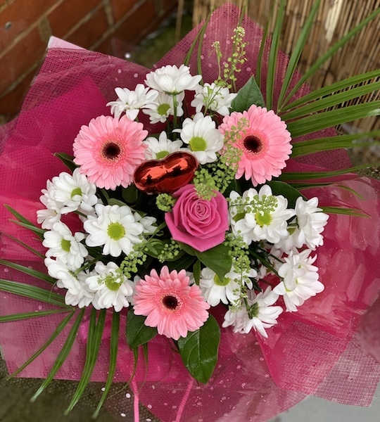 Pink germini flowers with white chrysanthemums and pink roses